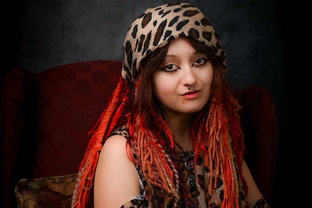 Studio light photography, young woman in leopard print with mix of yarn and natural hair.