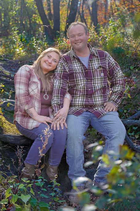 Portrait of a man and a woman in the woods holding hands